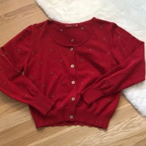 Red cardigan with flower detail. Size xl, fits a small well. Brand is liqimana.